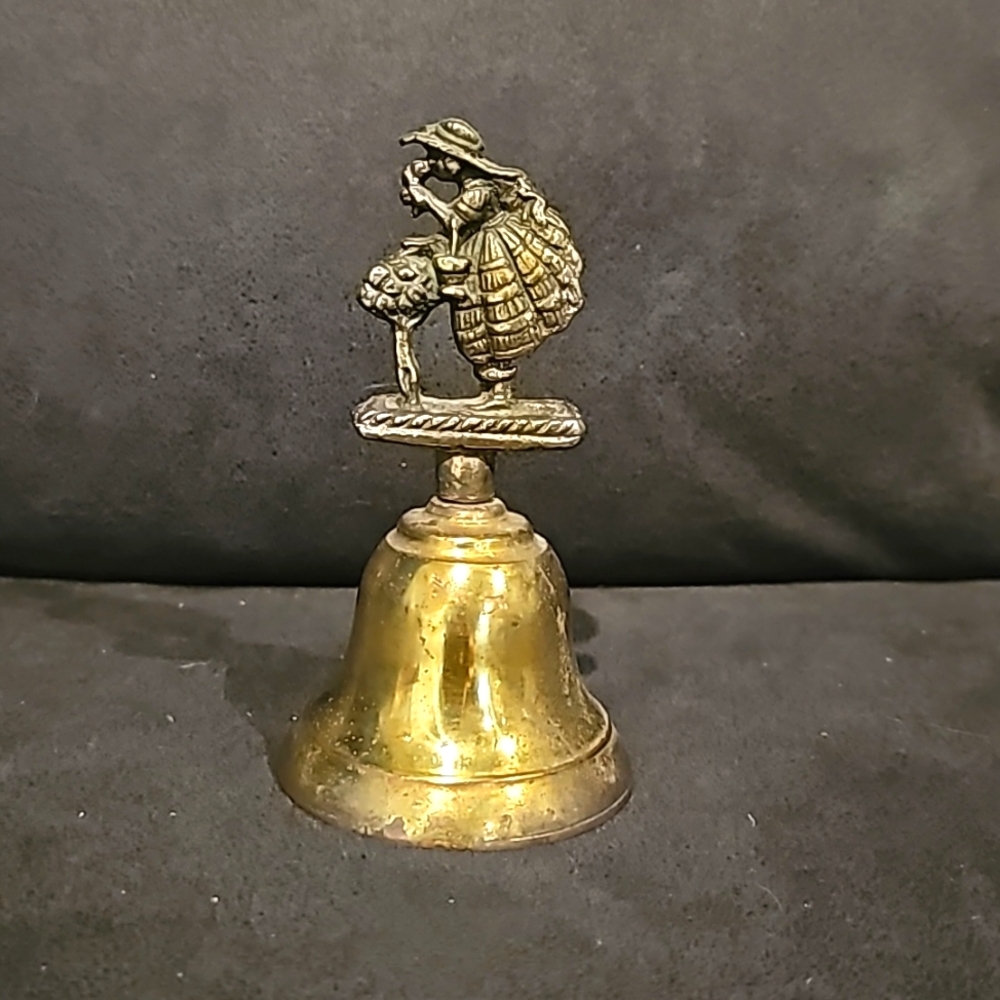 Vintage Victorian woman smelling flowers brass bell